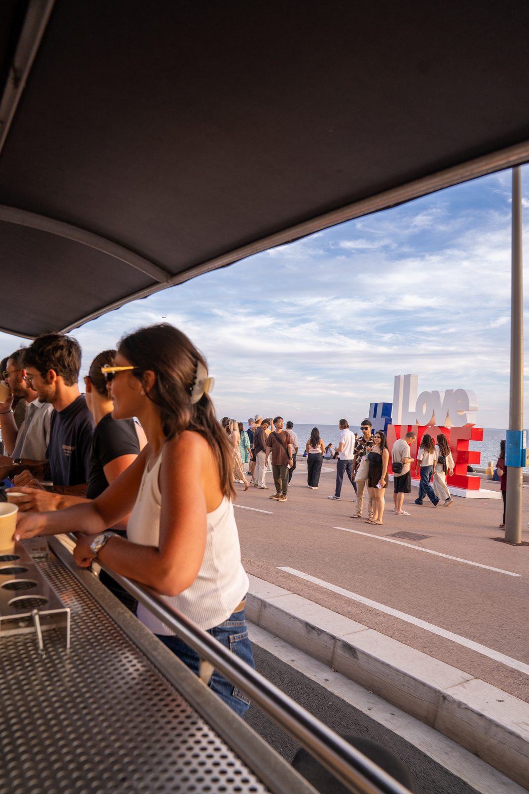Passagers du Sun Bike devant le panneau I Love Nice